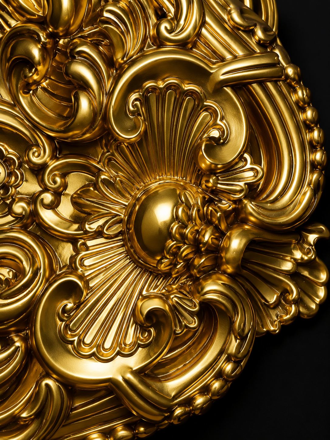 Gilded detail of one of the ornate gold mirrors